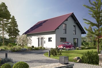 Fertighaus FingerHaus JUNO 402 mit heller Fassade, rotem Satteldach und gepflasterter Einfahrt mit Auto und Vorgarten bei Abendstimmung.