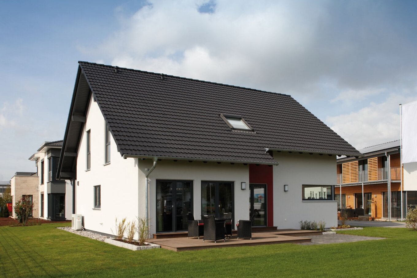 Rückansicht des Musterhauses VIO 400 in Köln mit Terrasse, großen Fenstern und modernem Satteldach.
