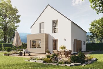 Fertighaus FingerHaus LIV 201 mit heller Fassade, dunklem Dach und Terrasse mit Sonnenschirm im sonnigen Garten mit Pflanzen und Blumen.