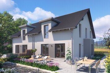 Haus FingerHaus DUO 243 mit grauer Putzfassade, dunklem Satteldach und großer Terrasse mit Esstisch, Liegestühlen und Blumenbeeten im sonnigen Garten.