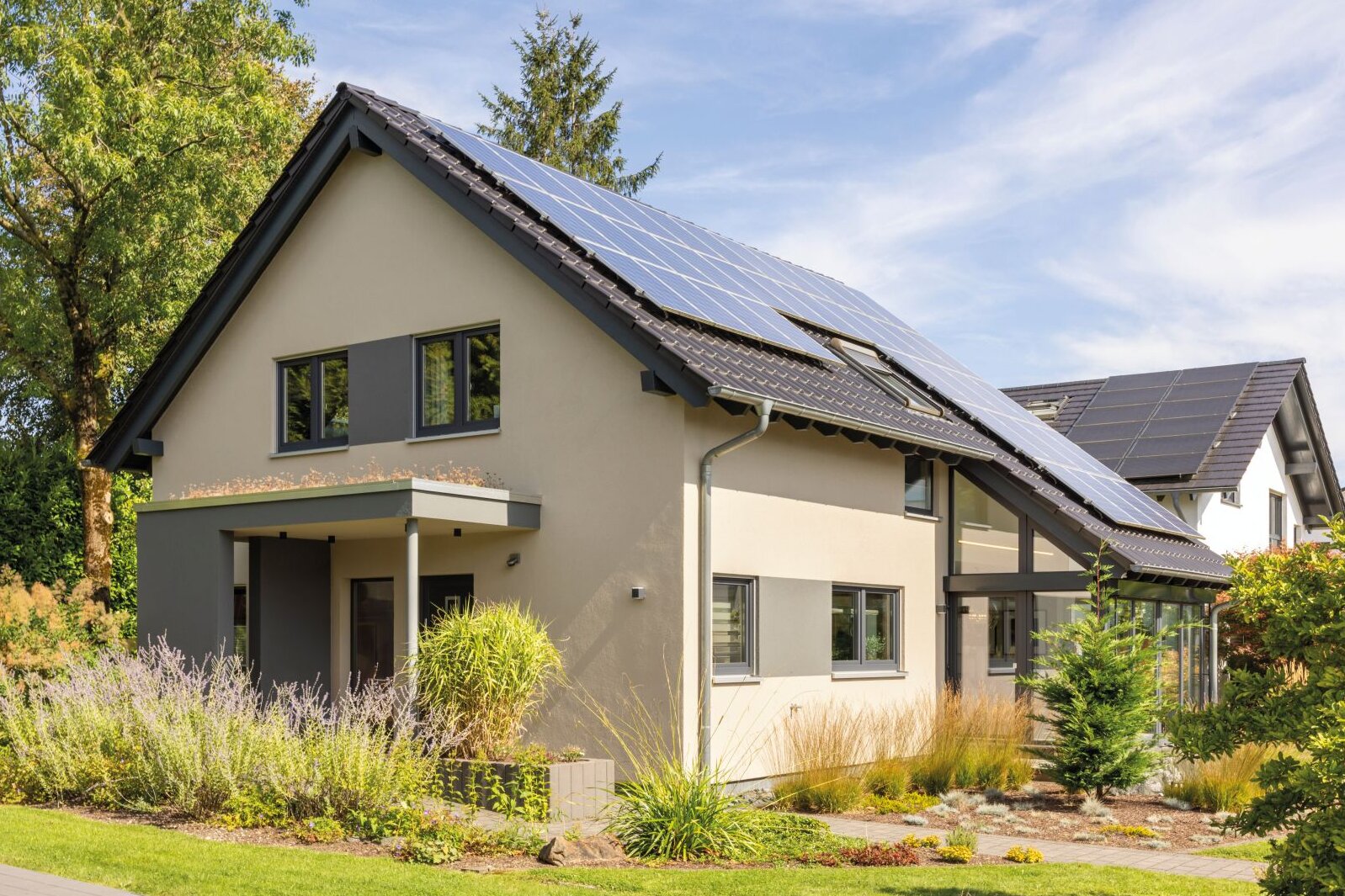 Modernes Musterhaus NEO in Wuppertal mit Satteldach, großzügigen Fenstern, Photovoltaikanlage und einladendem Garten.