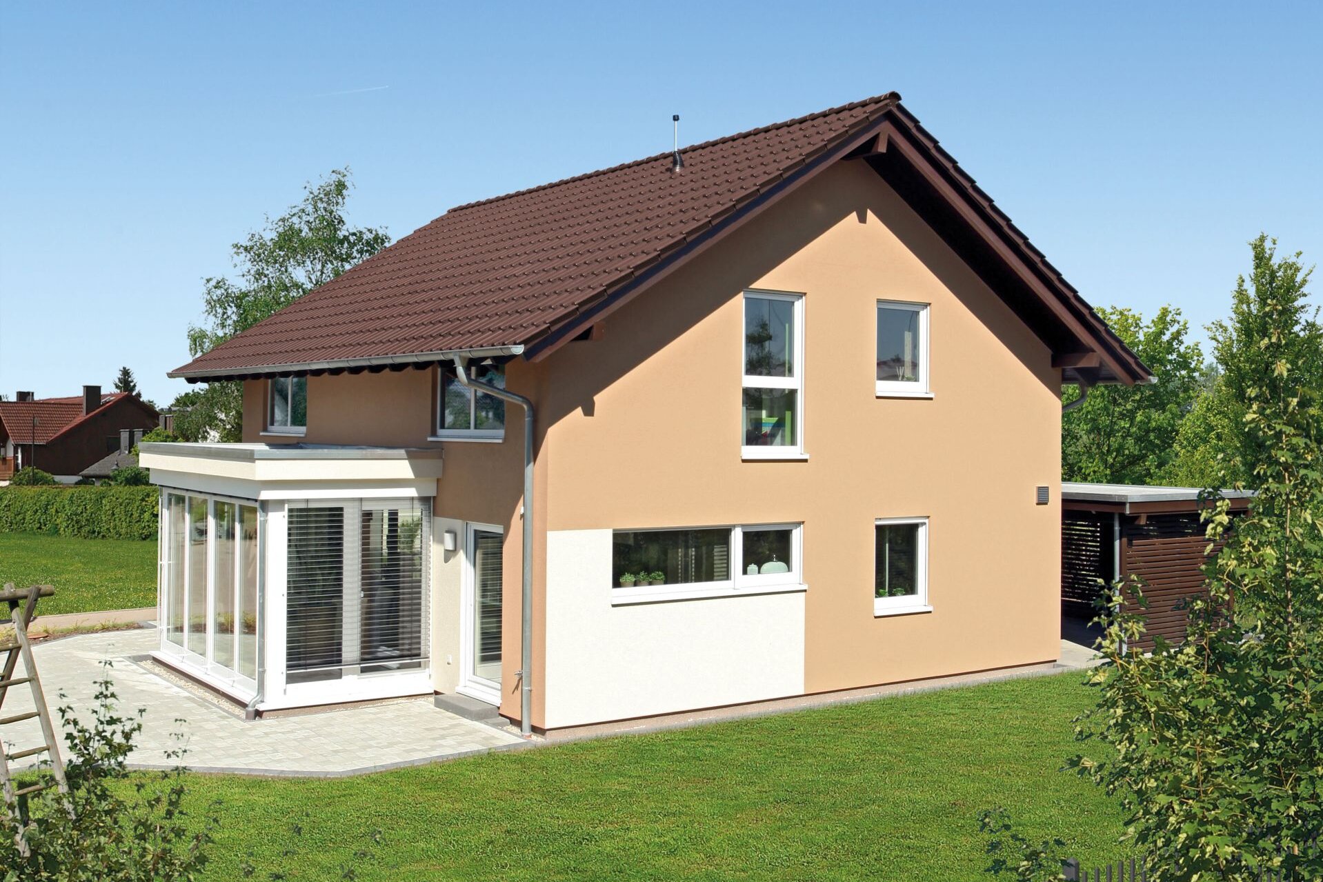 Außenaufnahme des MEDLEY 310 im Musterhaus Erfurt mit Garten und Wintergartenanbau.