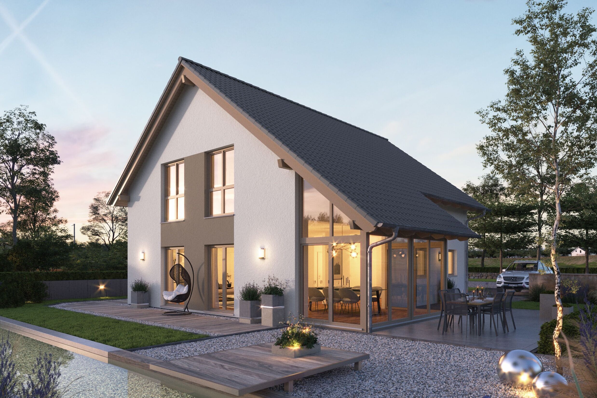 FingerHaus NEO 417 – modernes Einfamilienhaus mit Satteldach, weißer Fassade und großen Glasflächen in Abendstimmung. Im Vordergrund ein Garten mit Holzdeck, Sitzmöbeln, Kiesflächen und beleuchtetem Wasserbecken mit Seerosen.