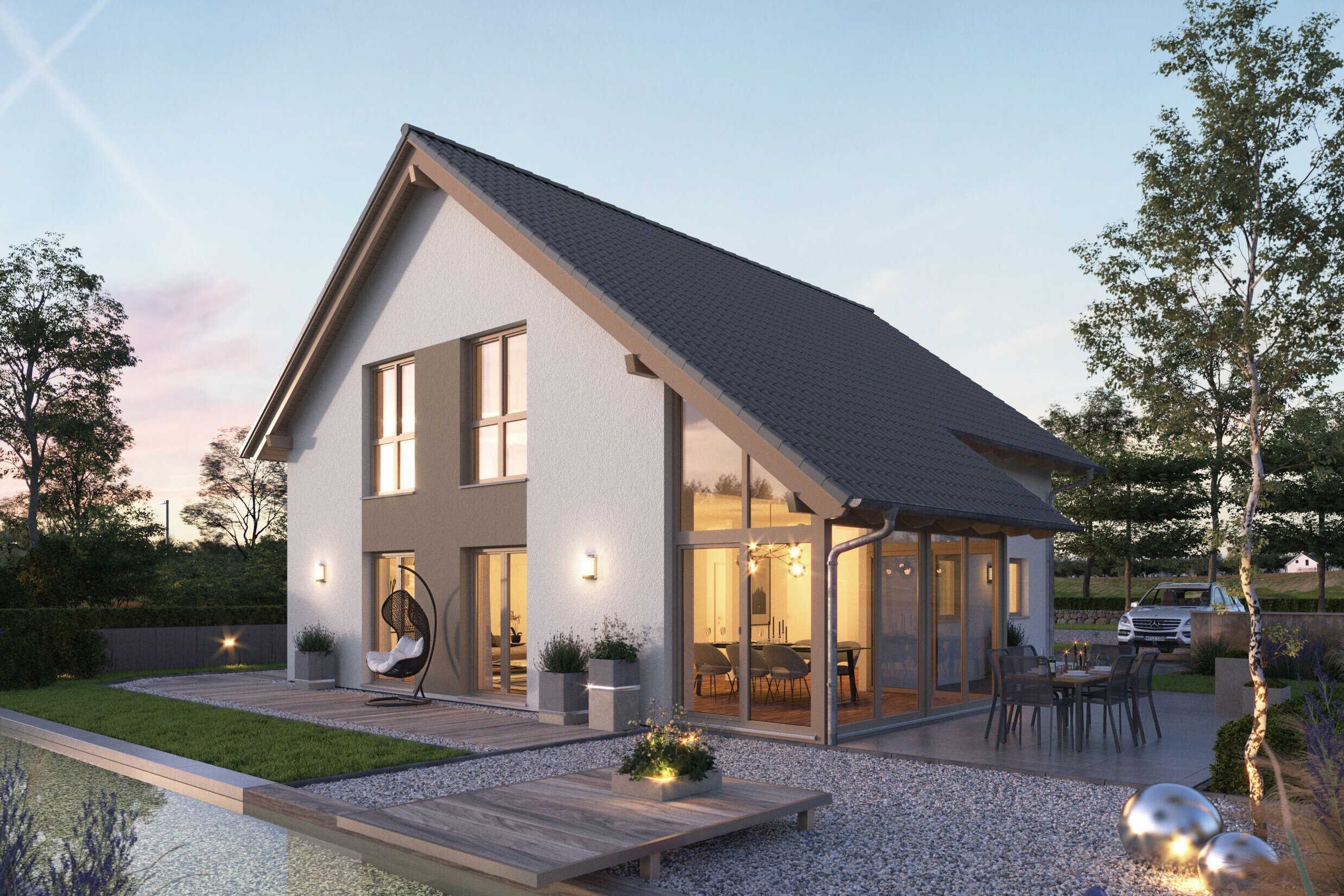 FingerHaus NEO 417 – modernes Einfamilienhaus mit Satteldach, weißer Fassade und großen Glasflächen in Abendstimmung. Im Vordergrund ein Garten mit Holzdeck, Sitzmöbeln, Kiesflächen und beleuchtetem Wasserbecken mit Seerosen.