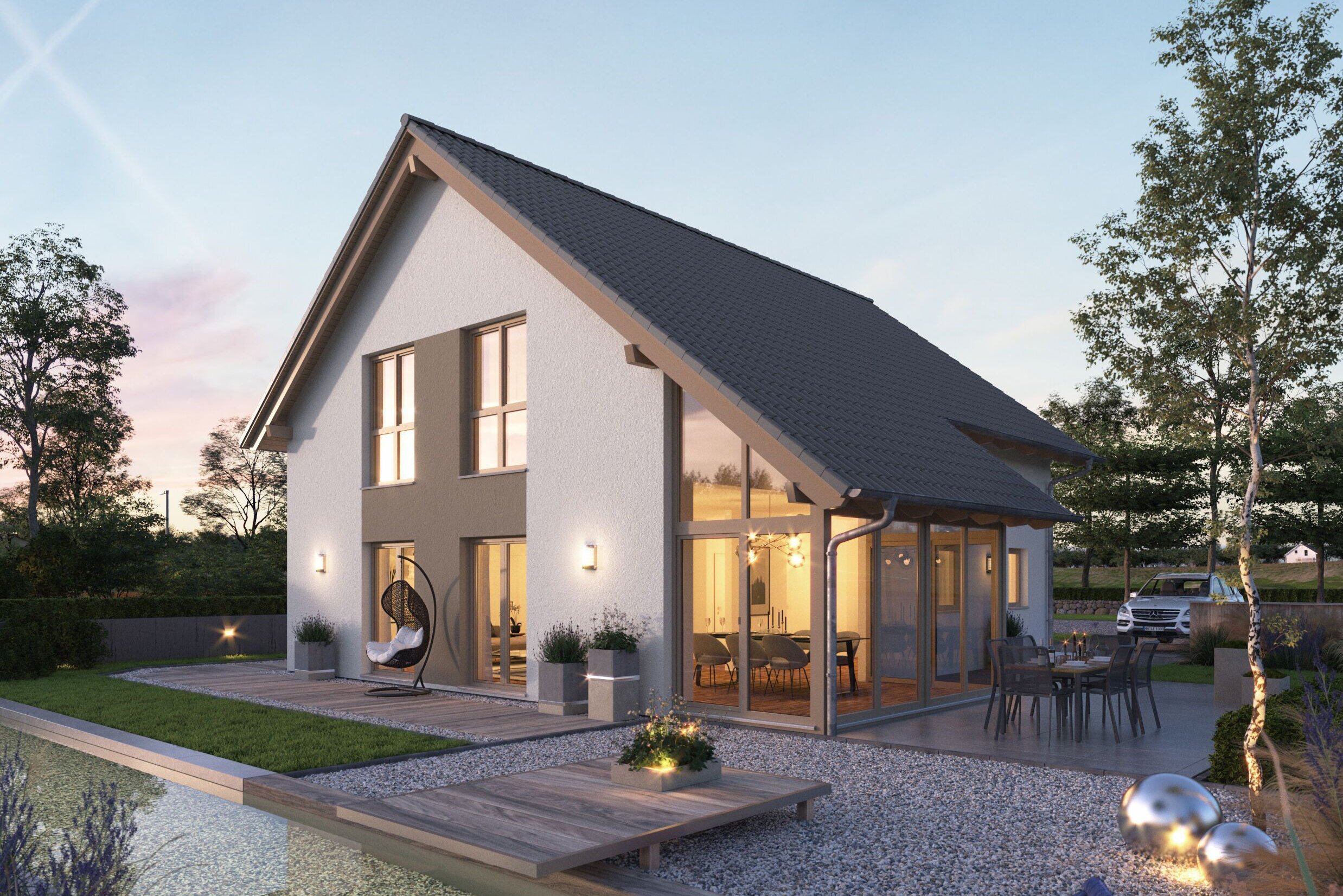 FingerHaus NEO 417 – modernes Einfamilienhaus mit Satteldach, weißer Fassade und großen Glasflächen in Abendstimmung. Im Vordergrund ein Garten mit Holzdeck, Sitzmöbeln, Kiesflächen und beleuchtetem Wasserbecken mit Seerosen.