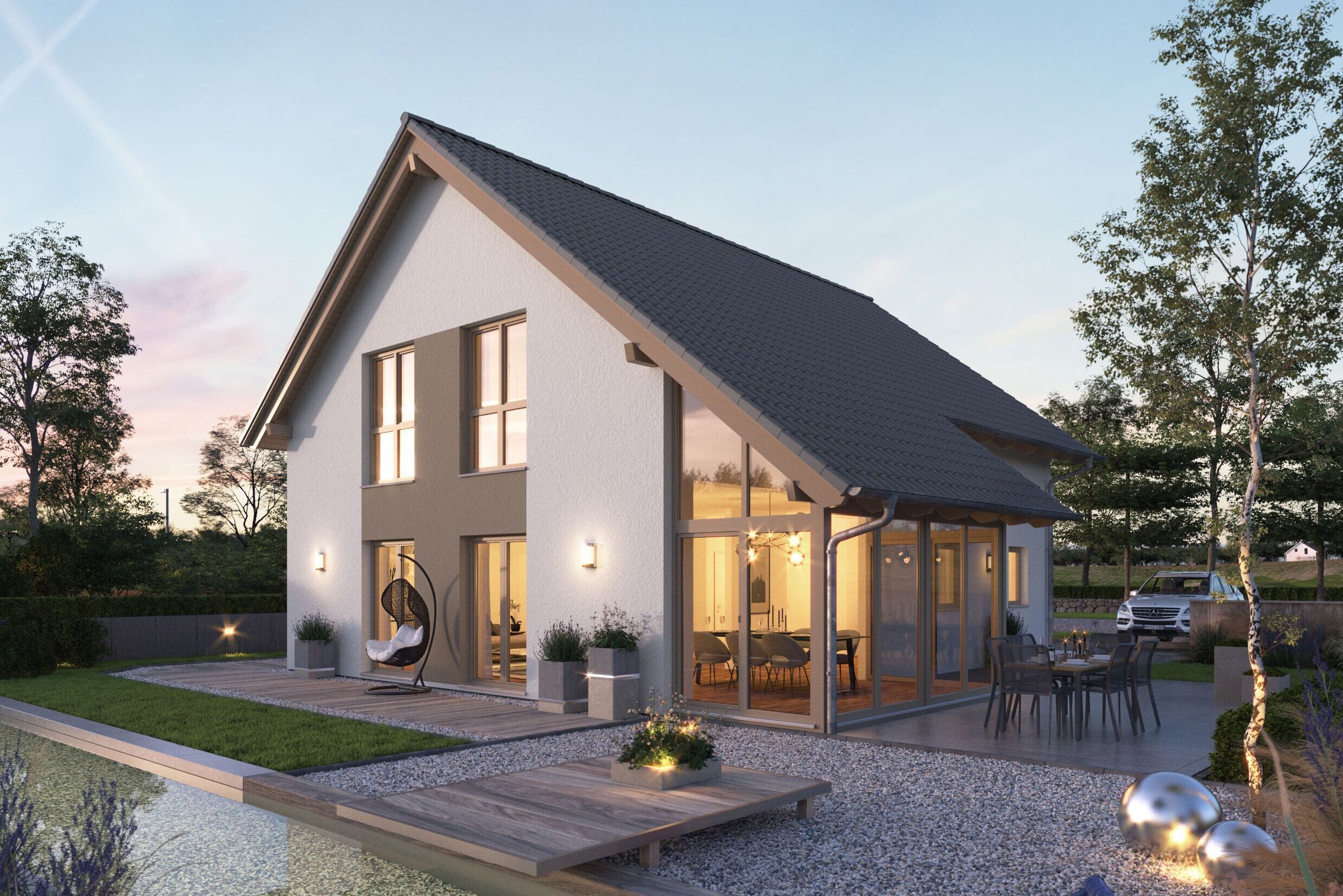 FingerHaus NEO 417 – modernes Einfamilienhaus mit Satteldach, weißer Fassade und großen Glasflächen in Abendstimmung. Im Vordergrund ein Garten mit Holzdeck, Sitzmöbeln, Kiesflächen und beleuchtetem Wasserbecken mit Seerosen.