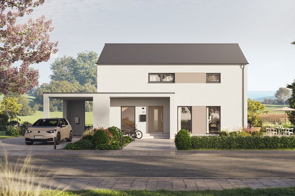 Fertighaus FingerHaus LIV 200 mit heller Fassade, Flachdach und Vorgarten mit bunten Blumen, Büschen und gepflasterter Zufahrt.