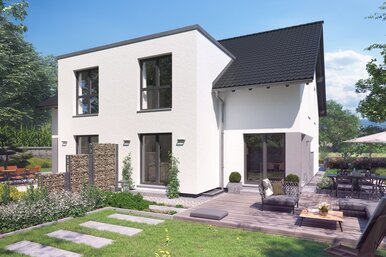 Zweigeschossiges Haus FingerHaus DUO 220 mit heller Fassade, dunklem Satteldach und moderner Terrasse im gepflegten Garten bei sonnigem Wetter.