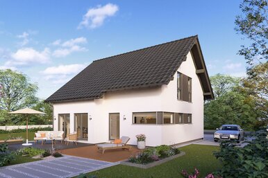 Modernes FingerHaus Fertighaus mit Satteldach, großen Fenstern und Terrasse mit Gartenmöbeln in grüner Umgebung