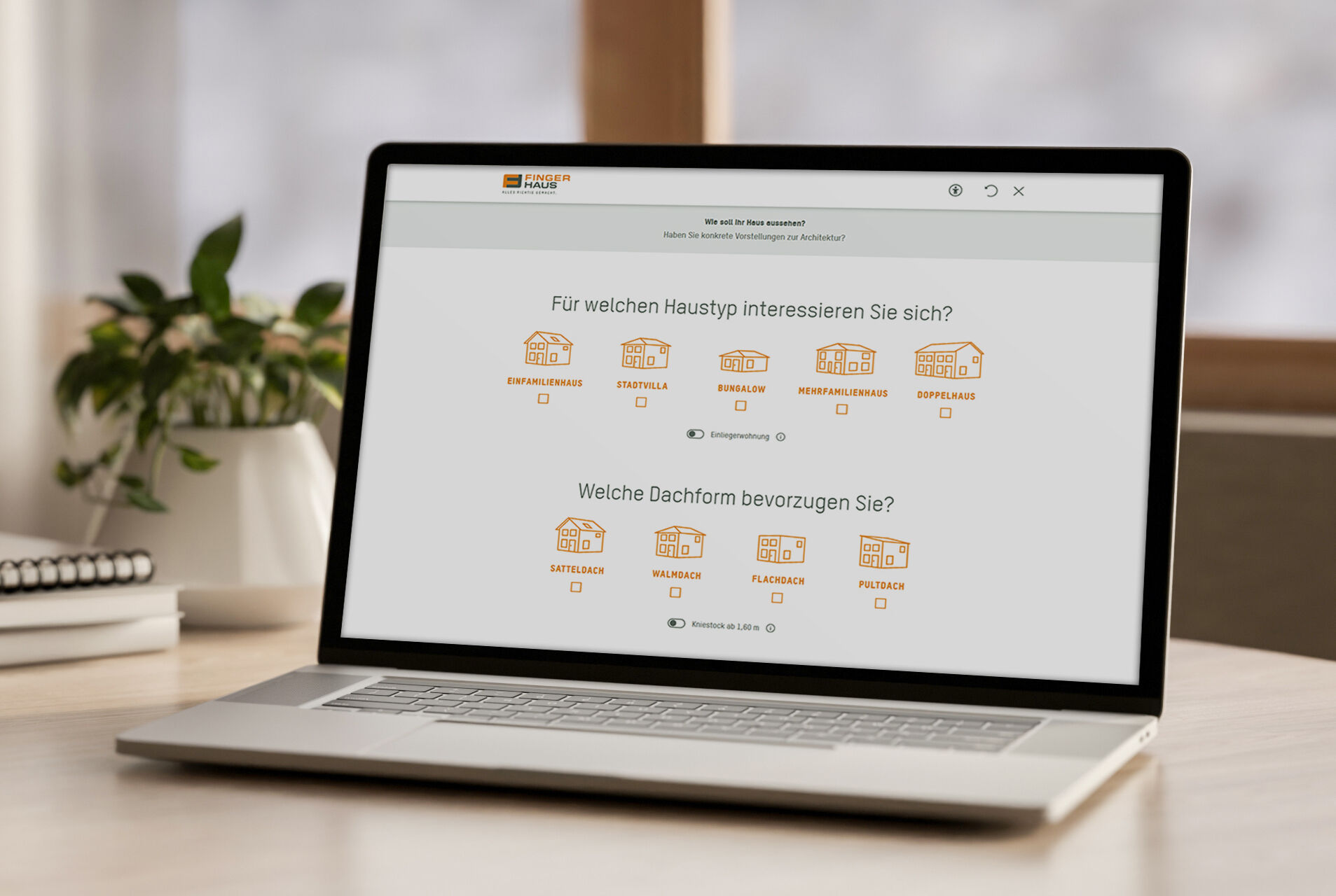 Erste Seite des digitalen Hausfinder-Tools von FingerHaus auf einem Laptop, mit Auswahl des Haustyps und der bevorzugten Dachform.